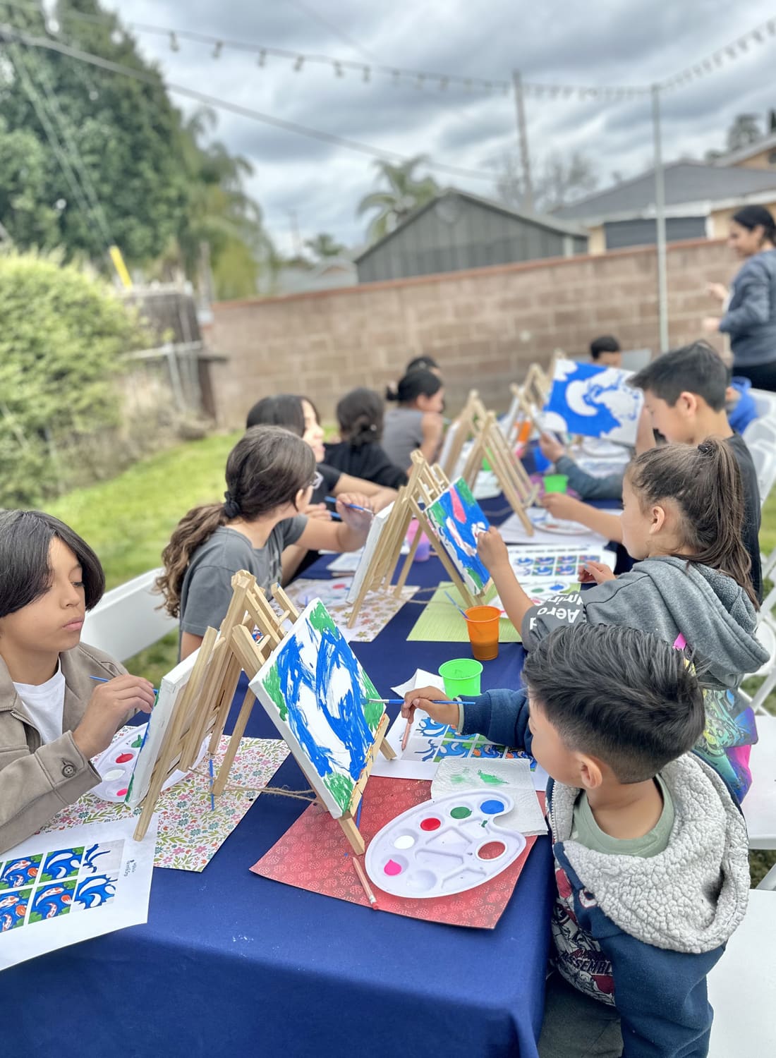 Young artists proudly sharing their colourful canvases