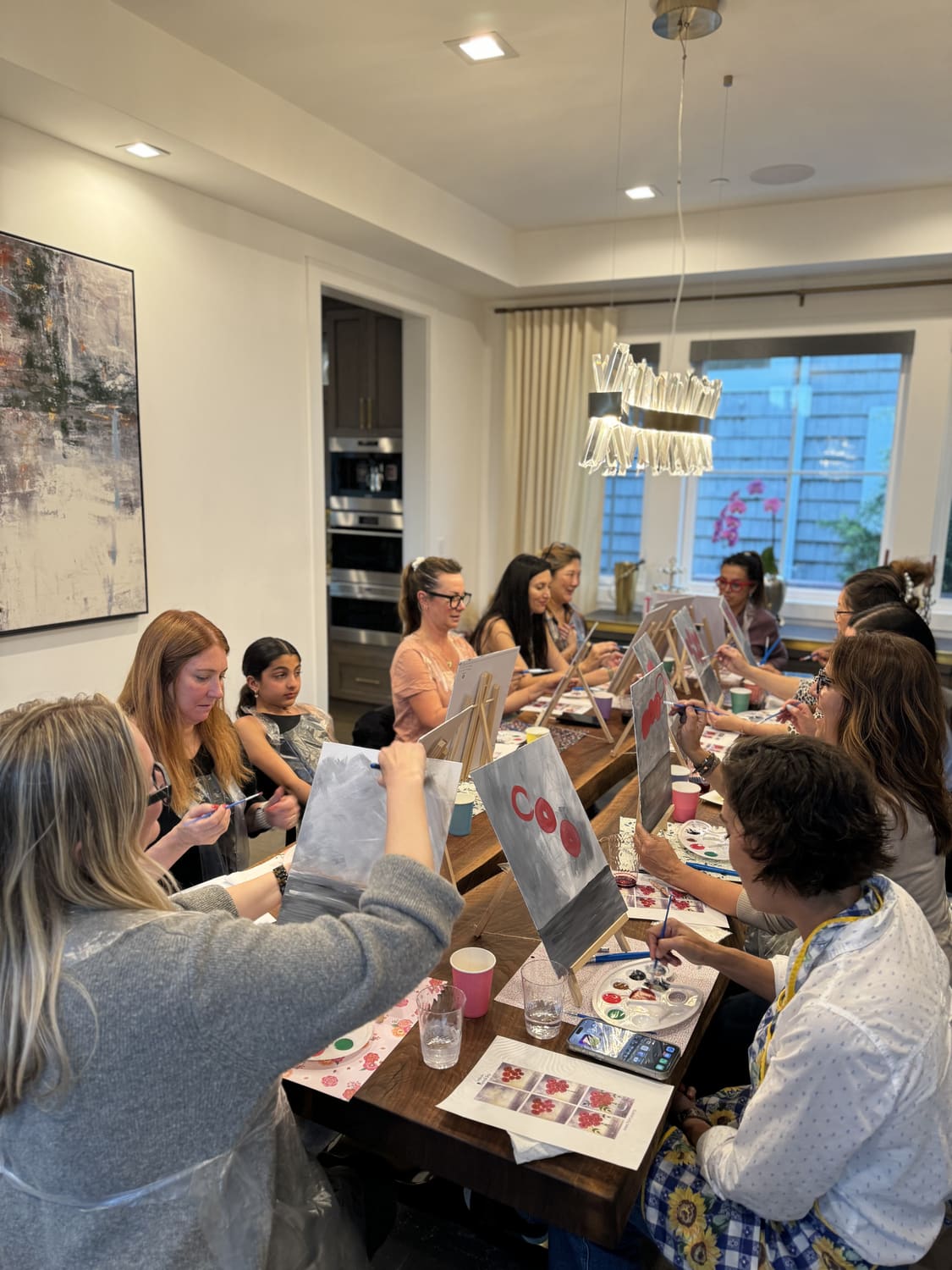 Friends enjoying a guided Paint Events painting experience