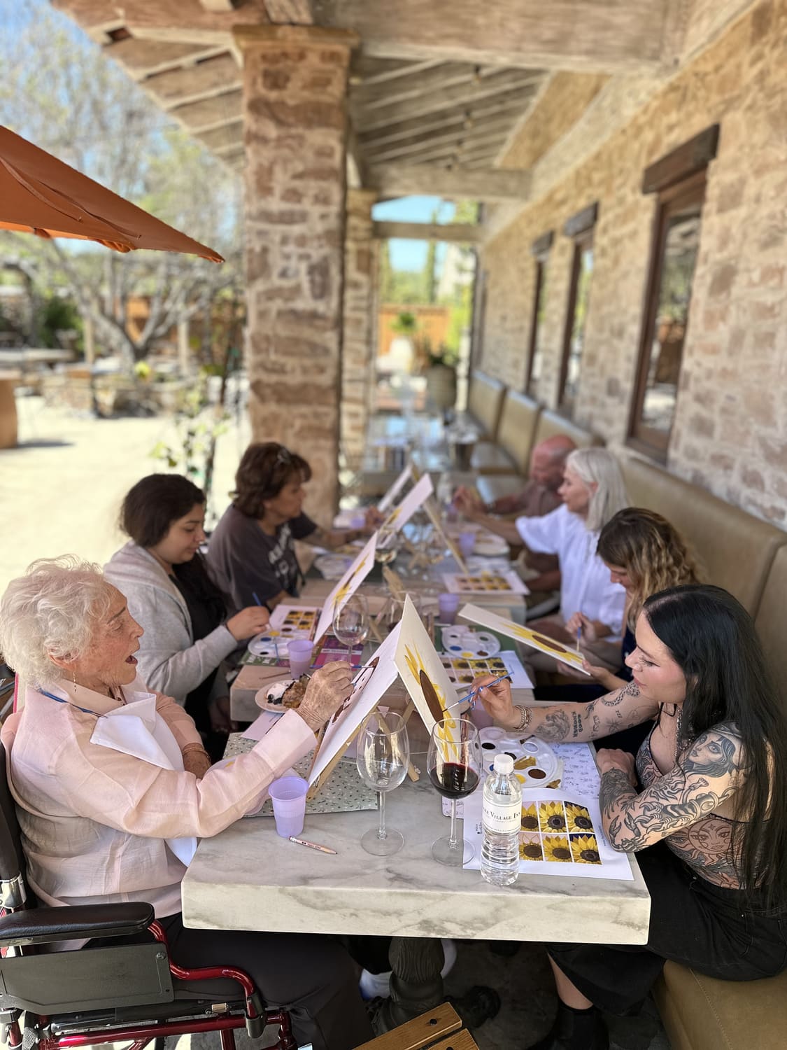 A community group painting together along a stone terrace